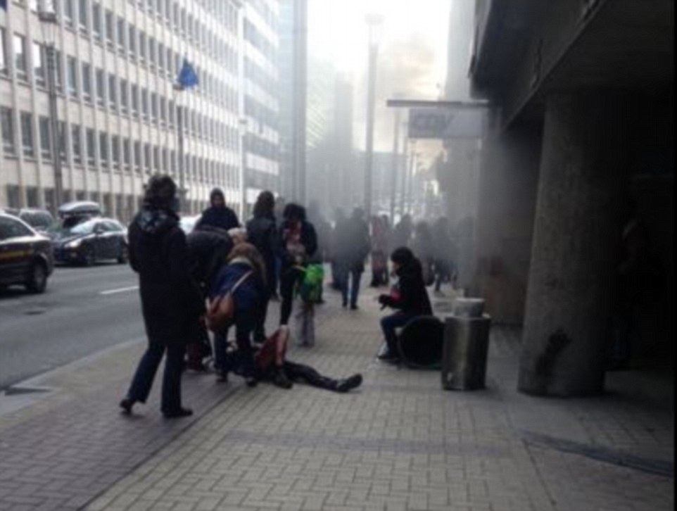 Second attack: A person lies injured on the floor after a explosion was heard at the Metro station in the centre of Brussels
