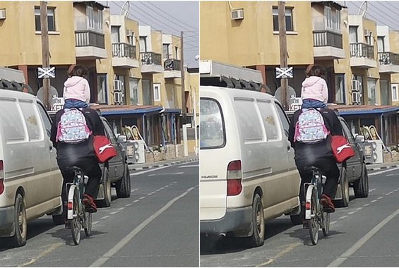 Τύπος οδηγεί το ποδήλατο του (σε κυπριακό δρόμο) και στους ώμους έχει φορτωμένο ένα κοριτσάκι