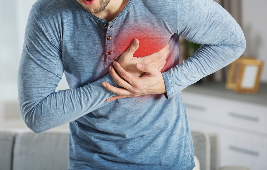 Heart attack concept. Man suffering from chest pain, closeup