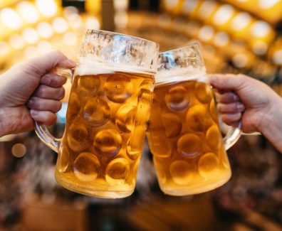 two-hands-clinking-beer-glasses-in-octoberfest-royalty-free-image-1585317187