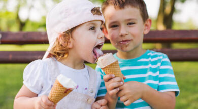 Cute little boy share ice cream with his sister