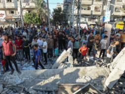 Palestinians react, after an Israeli air strike on a UN school sheltering displaced people, amid the Israel-Hamas conflict, in Nusairat