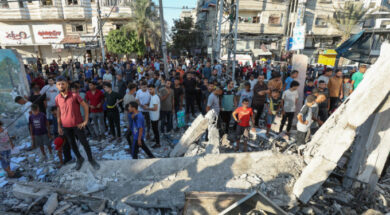 Palestinians react, after an Israeli air strike on a UN school sheltering displaced people, amid the Israel-Hamas conflict, in Nusairat