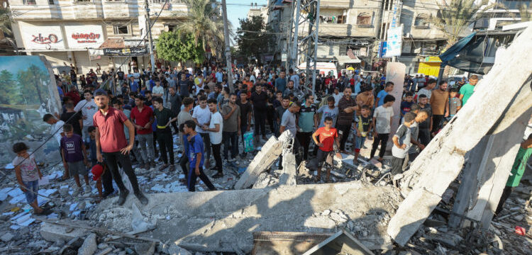 Palestinians react, after an Israeli air strike on a UN school sheltering displaced people, amid the Israel-Hamas conflict, in Nusairat