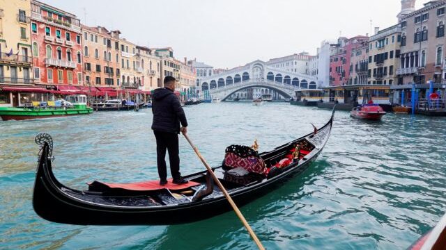 A gondola is pictured on Grand Canal in front of Rialto bridge in Venice