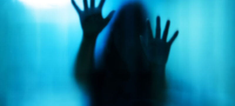 48188061 – abstract woman behind the matte glass. blurry hand and body figure