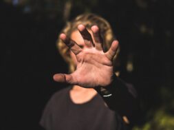Male’s palm of a hand covering his face