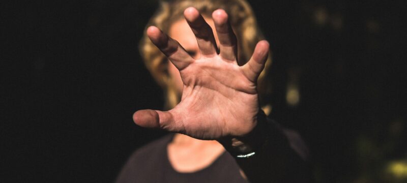Male’s palm of a hand covering his face