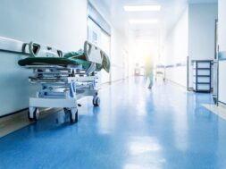 Doctors or nurses walking in hospital hallway, blurred motion.