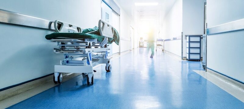 Doctors or nurses walking in hospital hallway, blurred motion.