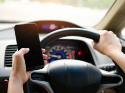 driver-with-phone-696×464