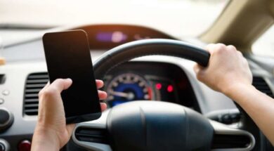 driver-with-phone-696×464