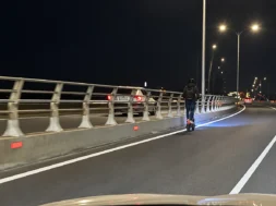 nighttime_highway_curve_with_scooter_rider